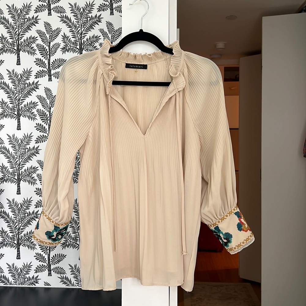 Cream blouse with unique sleeve design. In great condition!